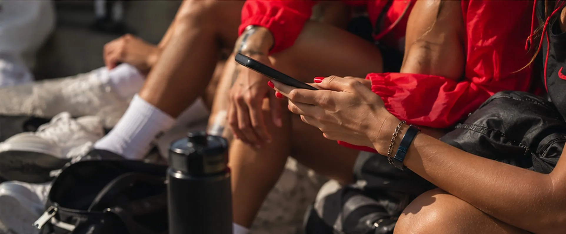 Creators with their phones, water bottles and running gear between workouts